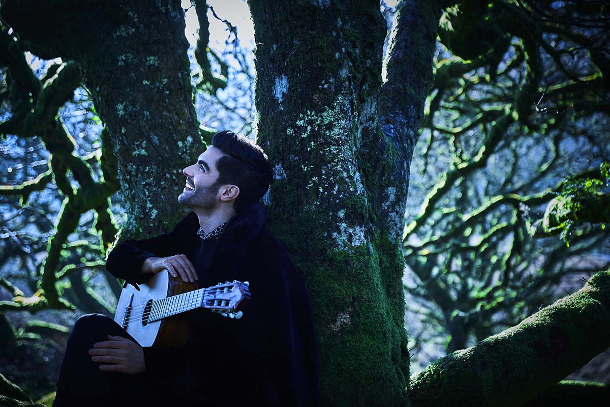 Milos in forest with guitar